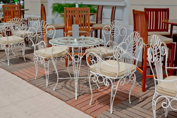 Restaurant, outdoor white chairs set and outdoor white chairs set at outdoor area.