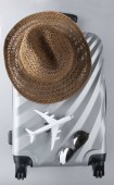 Картина, постер, плакат, фотообои "flat lay grey suitcase with mini airplane and sun hat on grey ba", артикул 300236926
