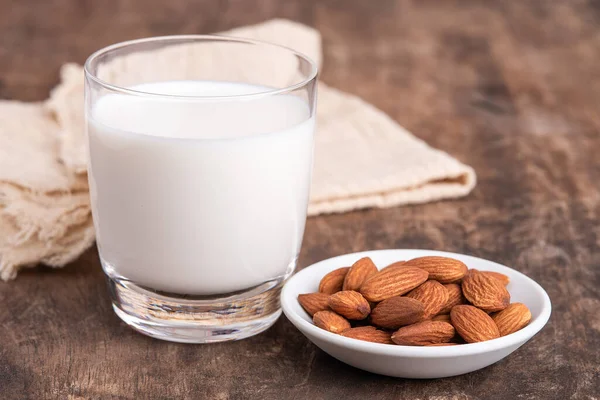 Close Up glass of Almond milk with Almond seeds. Almond milk in a glass with almonds