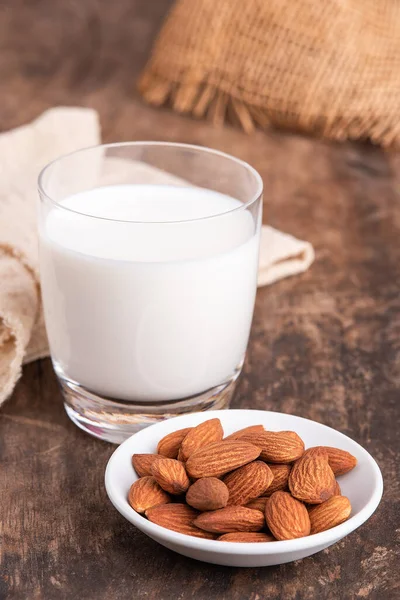 Close Up glass of Almond milk with Almond seeds. Almond milk in a glass with almonds