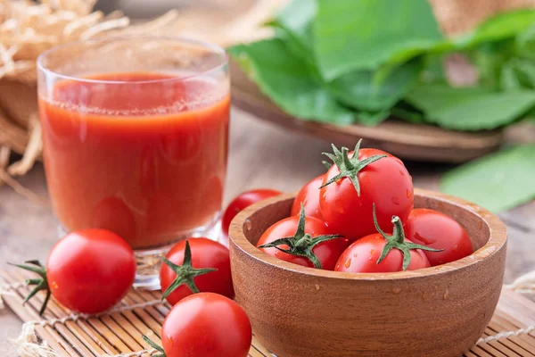 Tomato juice. Glass of tomato juice with vegetables on wooden background