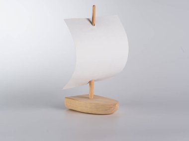 Hafif bir arka plan üzerinde bir yelken ile Oyuncak ahşap tekne. El yapımı