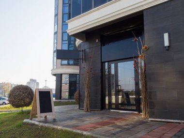 Yeni bir modern binanın butiğinin girişini dekore etmek için bir model. Koyu dış fayanslar güzel ve şık bir görünüm yaratıyor. Boş kimlik modeli