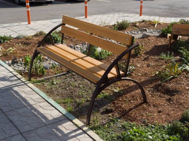 An interesting structural bench made of metal and wood. Theme of street improvement