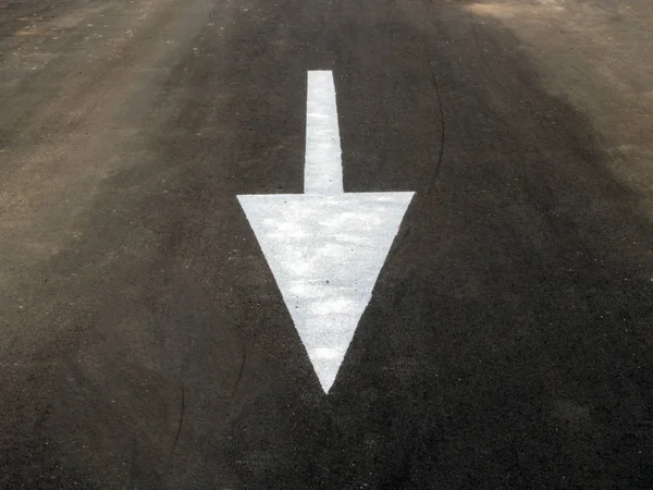 Arrow on the pavement towards us. The theme of signs and symbols surrounding us