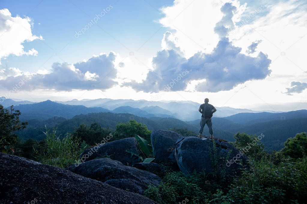 Man on a stone observing the landscape