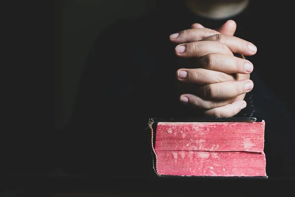 Woman praying on holy bible in the morning. Teenager woman hand with Cross and Bible praying, Hands folded in prayer on a Holy Bible in church concept for faith, spirituality and religion.
