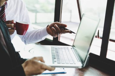 Dizüstü bilgisayar ve belgeleri ofisinde çalışan iş adamı 