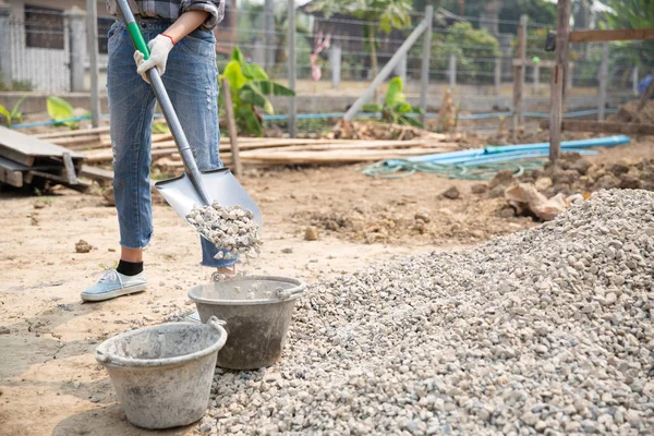 Trabajadores de la construcción llevando una pala al sitio de construcción —  Fotos de Stock