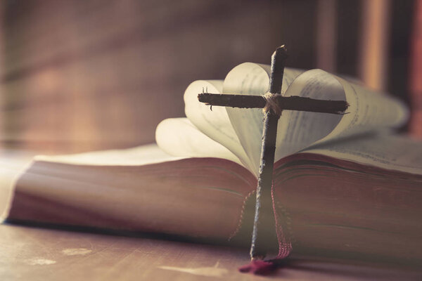 Ancient religious book and wooden cross 