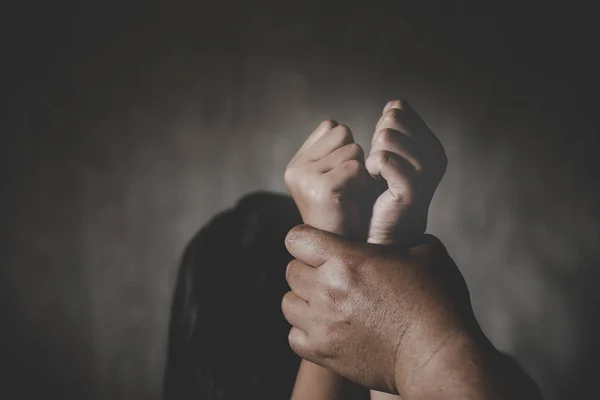 Violencia infantil. La mano del hombre sosteniendo las manos de la chica apretada —  Fotos de Stock