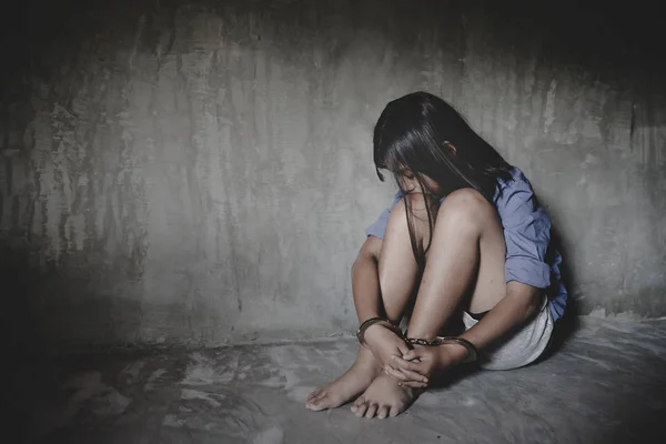 Arrested child with handcuffs on black background. — Stock Photo, Image