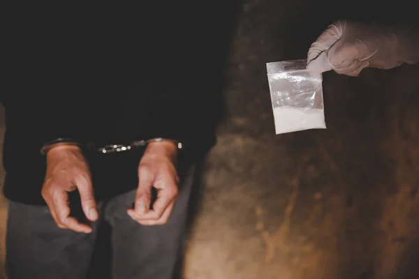 Illegal transport of drugs. A police officer finds drugs during the search of drug dealers. — Stock Photo, Image