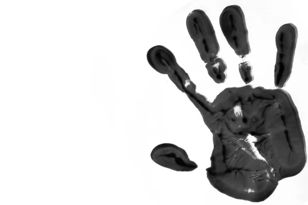Huella de mano de color negro sobre un fondo blanco . — Foto de Stock