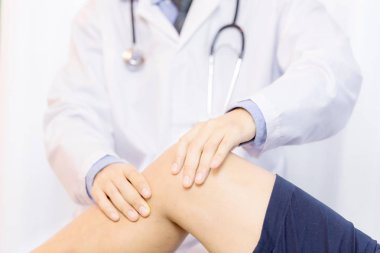 erkek fizyoterapist bir fizyoterapi odasında hastanın bacak masaj.