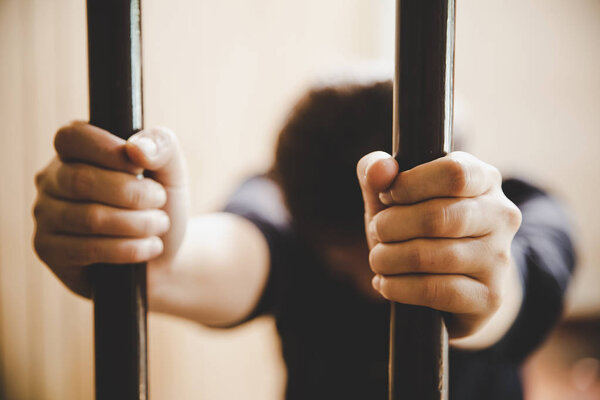 beautiful young girl behind the bars