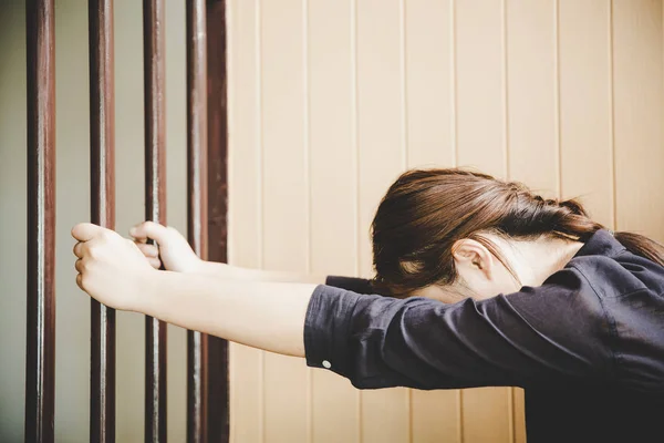 Beautiful young girl behind the bars — Stock Photo, Image