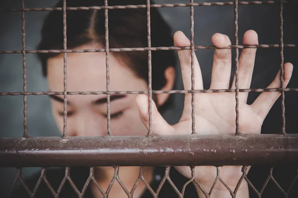 Beautiful young girl behind the bars — Stock Photo, Image