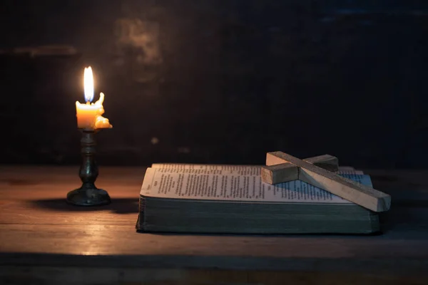 Wood cross laying on an opened Bible — Stock Photo, Image