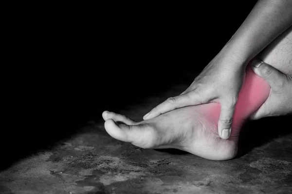 Closeup woman suffering from pain in ankle — Stock Photo, Image