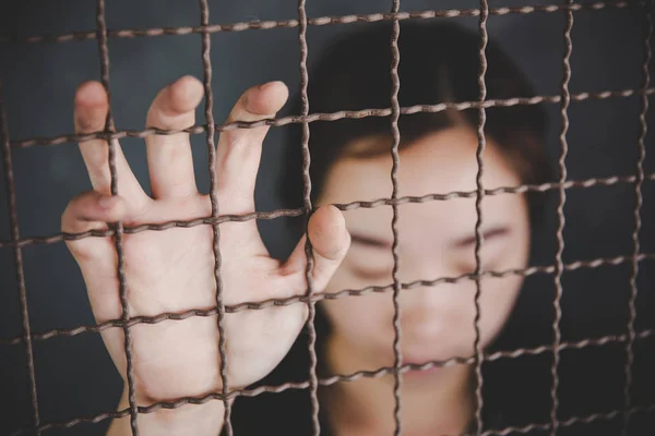 Beautiful young girl behind the bars — Stock Photo, Image