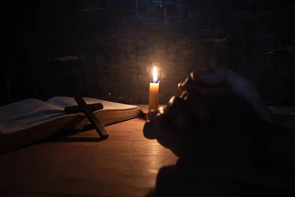 Women praying on the Bible in the light candles selective focus. — Stock Photo, Image