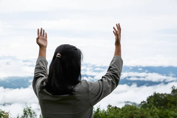 Happy teens deep breath fresh air on top mountain breathing clea