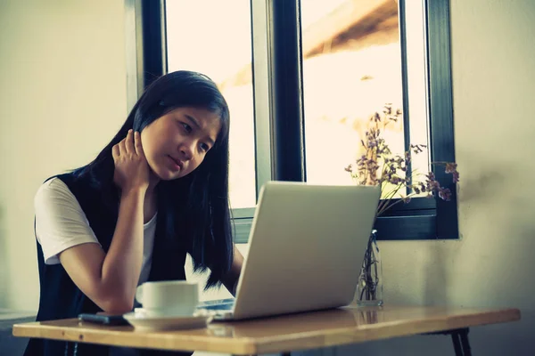 Stressed business woman working on wooden table in coffee shop