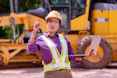 Kadın mühendisler inşaat işçisi. Foreman inşaat alanında kazıcıyla birlikte çalışıyor..
