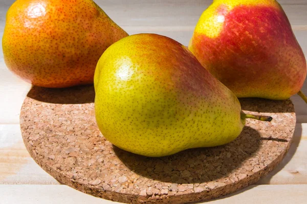 Three pears on a prop stand, closeup