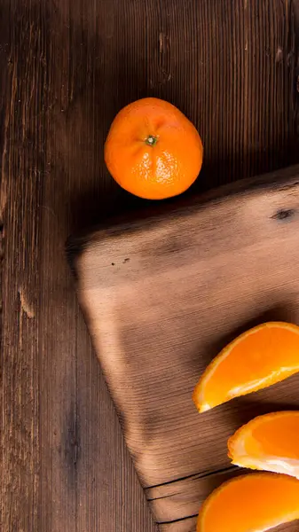Ganze Mandarinen Scheiben Auf Einem Schneidebrett Alter Dunkler Holztisch Nahaufnahme — Stockfoto