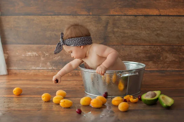 Niña de un año se baña con frutas. — Foto de Stock