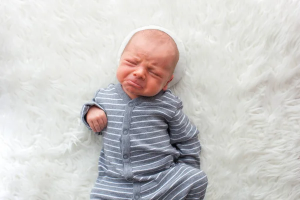 Newborn baby boy. Portrait of a little boy on white fur. — Stock Photo, Image