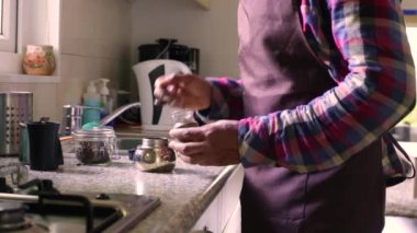 Moka pot ile espresso yapan kişiye yakın çekim.