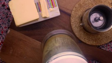 close up man making nutricious coffee with butter 