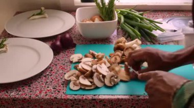 Closeup chef chopping organic mushrooms in kitchen