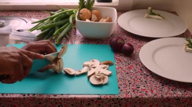 Closeup chef chopping organic mushrooms in kitchen