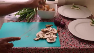 Closeup chef chopping organic mushrooms in kitchen