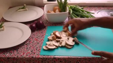 Closeup chef chopping organic mushrooms in kitchen