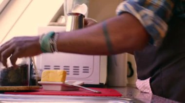 Person preparing keto coffee with butter and MCT oil at home