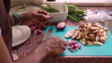 Closeup of chef chopping organic onions and mushrooms          