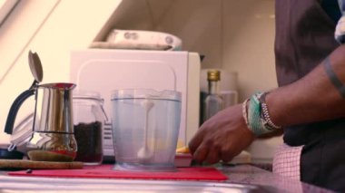 Person preparing keto coffee with butter and MCT oil at home