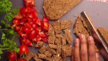 Chopping bread and fresh tomatoes