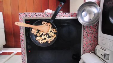 Top view chef preparing shrimps on electric stove