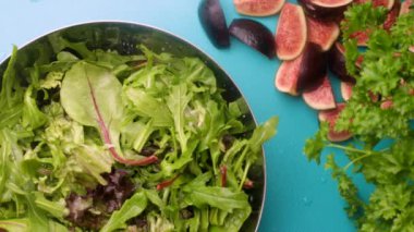 Preparing fresh salad with figs