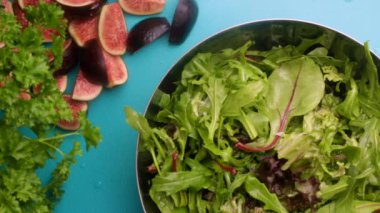 Preparing fresh salad with figs