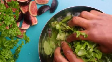 15 seconds video. Video of a person preparing a fresh, healthy salad with greens and figs.