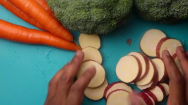 Person hands preparing organic vegetables for healthy meal in kitchen