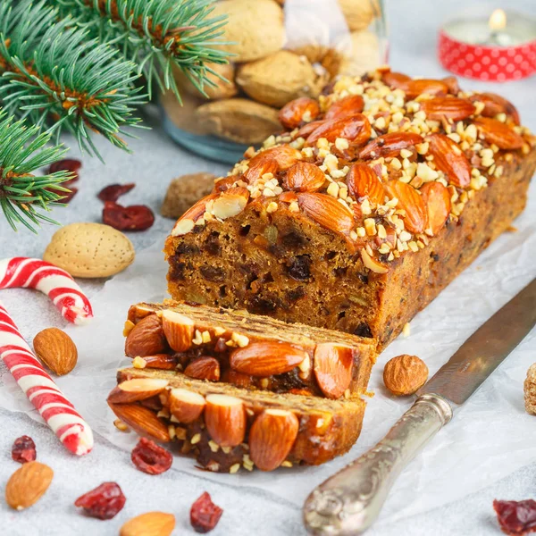 Fruitcake. Traditional Christmas cake with almonds, dried cranberries, cinnamon, cardamom, anise, cloves.  New year. Selective focus. Square picture