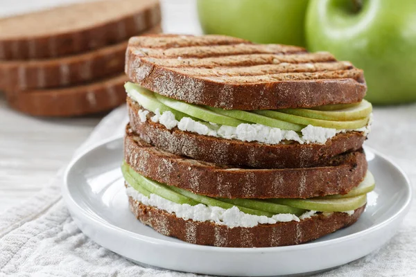 Delicious rye bread sandwich with ricotta and green Apple. Panini. Gourmet Breakfast. Selective focus